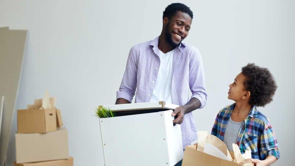 Expert packers wrapping fragile items with bubble wrap and boxes in Dubai apartment relocation.